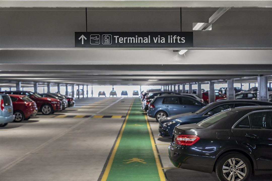 Vehicles lined up at an airport parking area