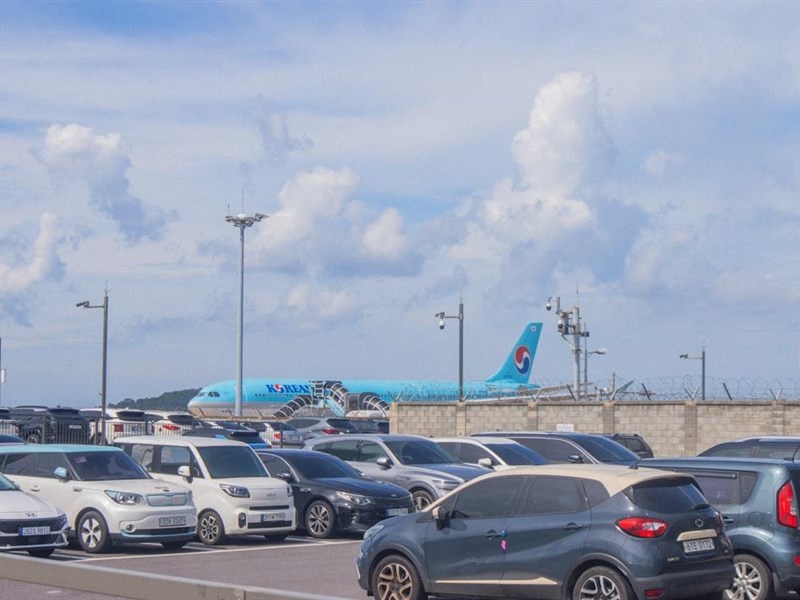 A white shuttle bus parked at a terminal